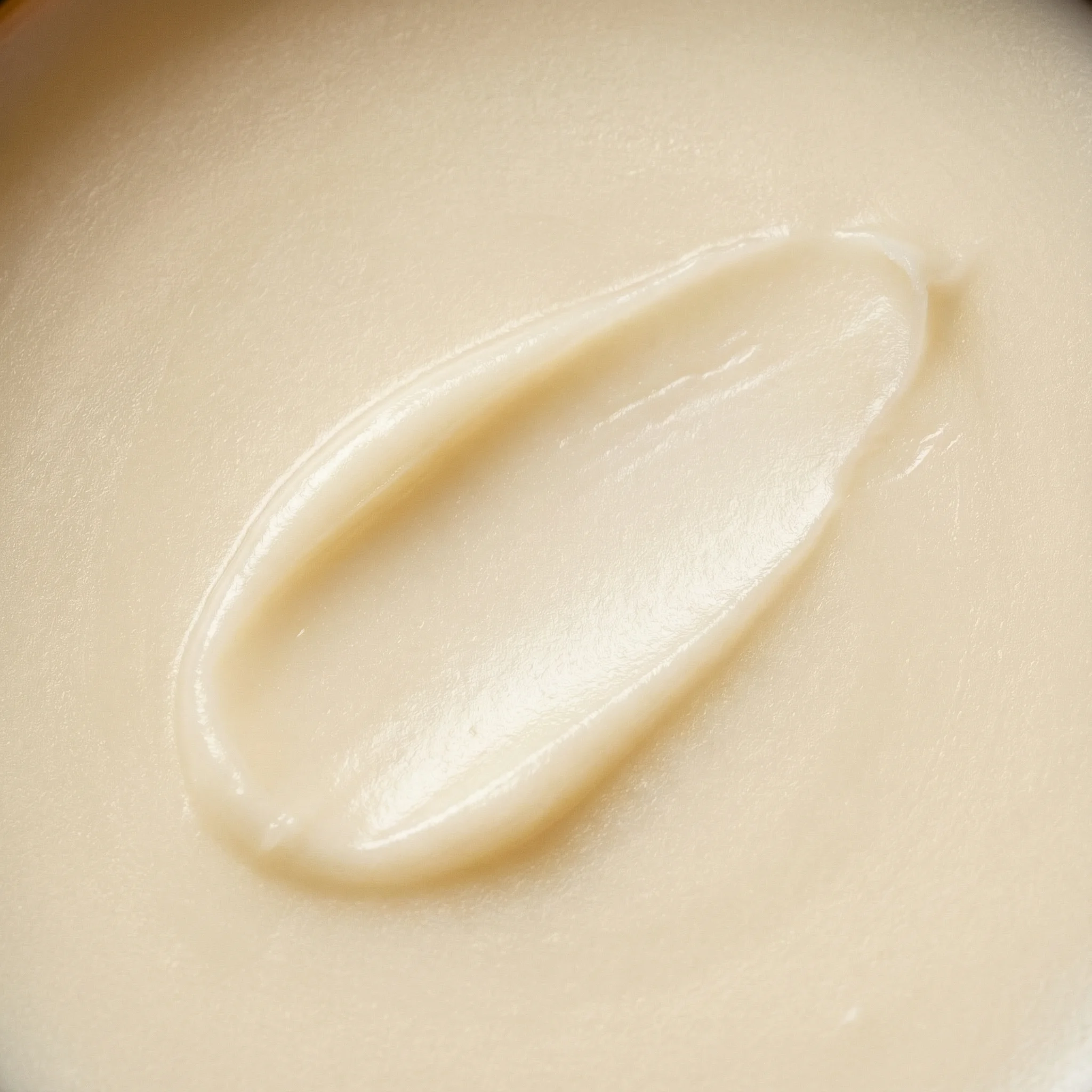 Smooth tallow balm smear showing creamy golden texture